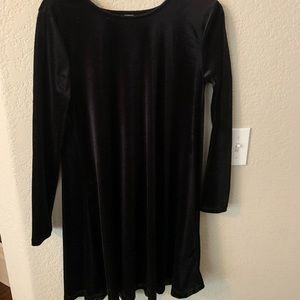 A black long sleeve mid length dress